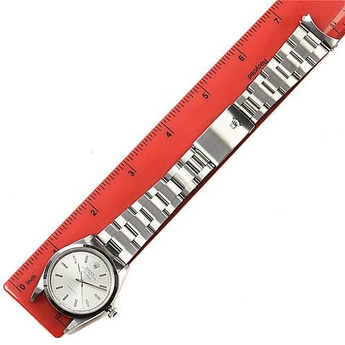 The Rolex Air-King 14000M Men's Stainless Steel Silver Dial 14000M Men's Stainless Steel Silver Dial watch is shown laid flat, with the face and bracelet visible alongside a red ruler.