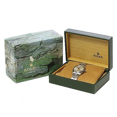 The Rolex Air-King 14000M Men's Stainless Steel Silver Dial 14000M Men's Stainless Steel Silver Dial watch is shown at an angled view inside its open green and tan box, with a green external box beside it.