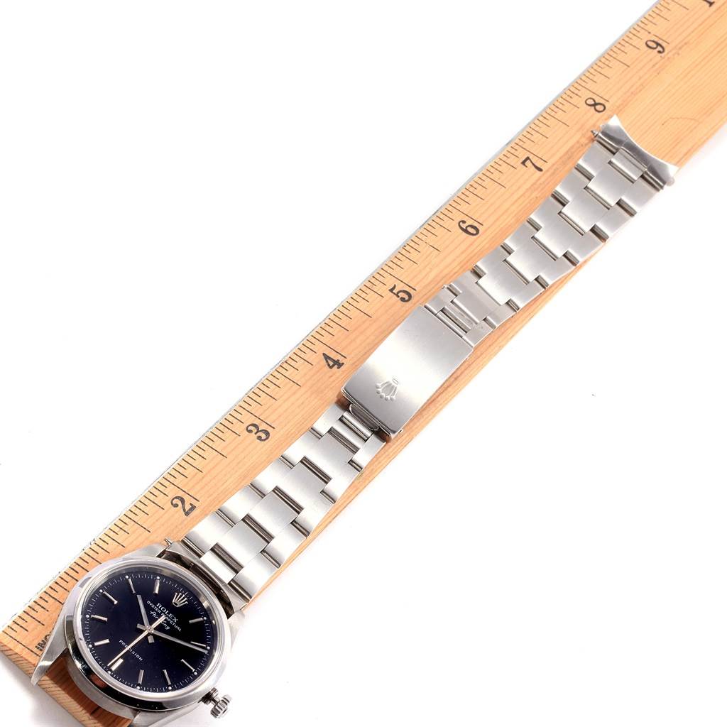 The image shows a Rolex Air-King 14000 Men's Stainless Steel Black Dial 14000 Men's Stainless Steel Black Dial watch laid flat next to a ruler, displaying its face, bracelet, and clasp.