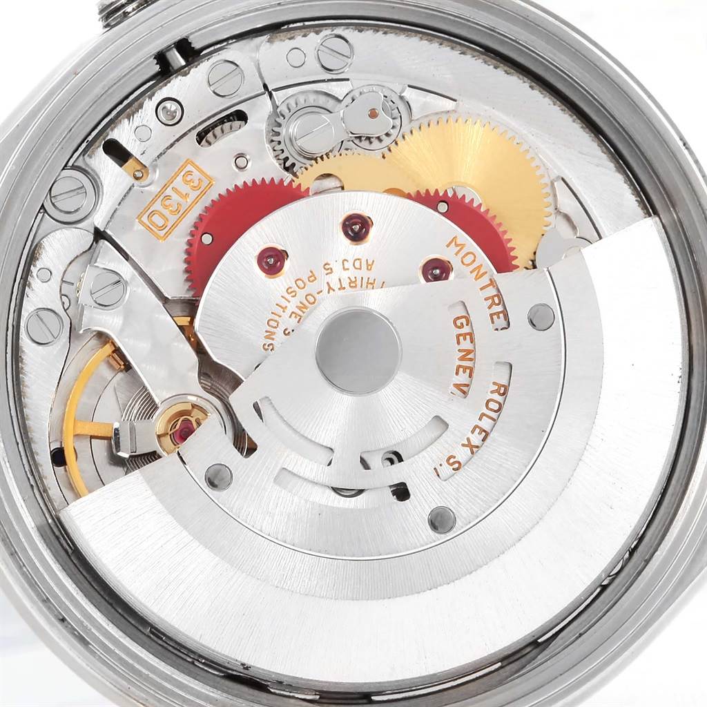 The image shows the intricate inner mechanisms of the Rolex Air-King 14010 Men's Stainless Steel Silver Dial 14010 Men's Stainless Steel Silver Dial watch, including gears, cogs, and the rotor.