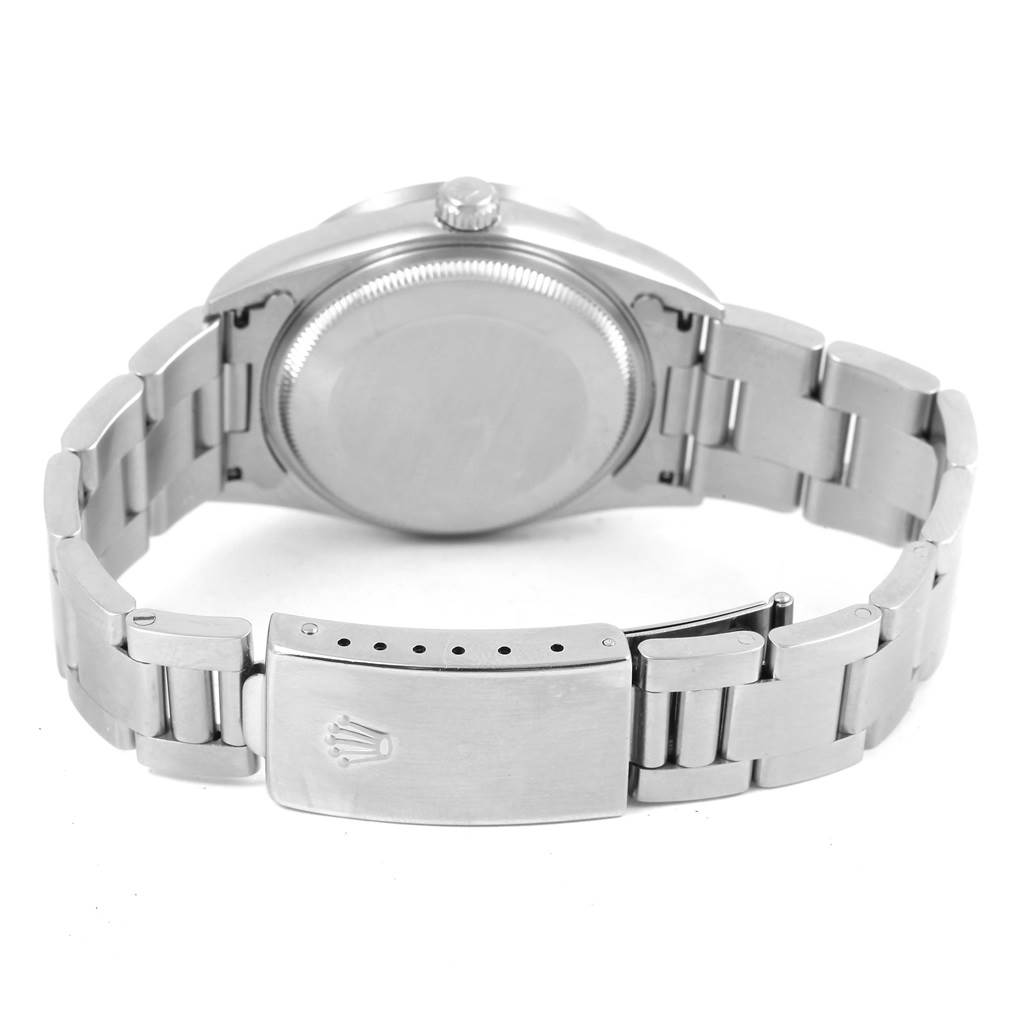 The image shows the back view of a Rolex Air-King 14010 Men's Stainless Steel Silver Dial 14010 Men's Stainless Steel Silver Dial watch, featuring the case back and the clasp of the metal bracelet.