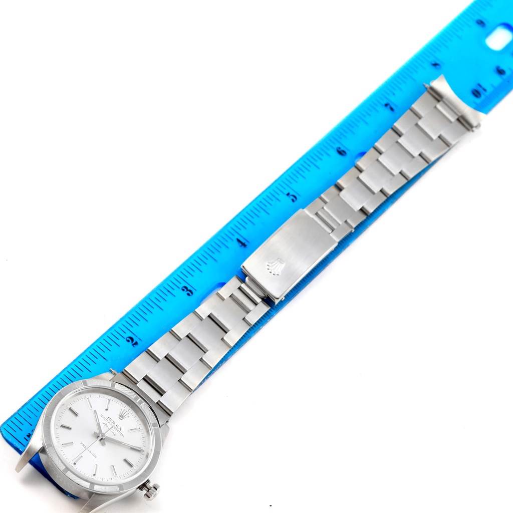 The image shows a top-down view of a Rolex Air-King 14010 Men's Stainless Steel Silver Dial 14010 Men's Stainless Steel Silver Dial watch, including its face, bracelet, and clasp alongside a ruler.