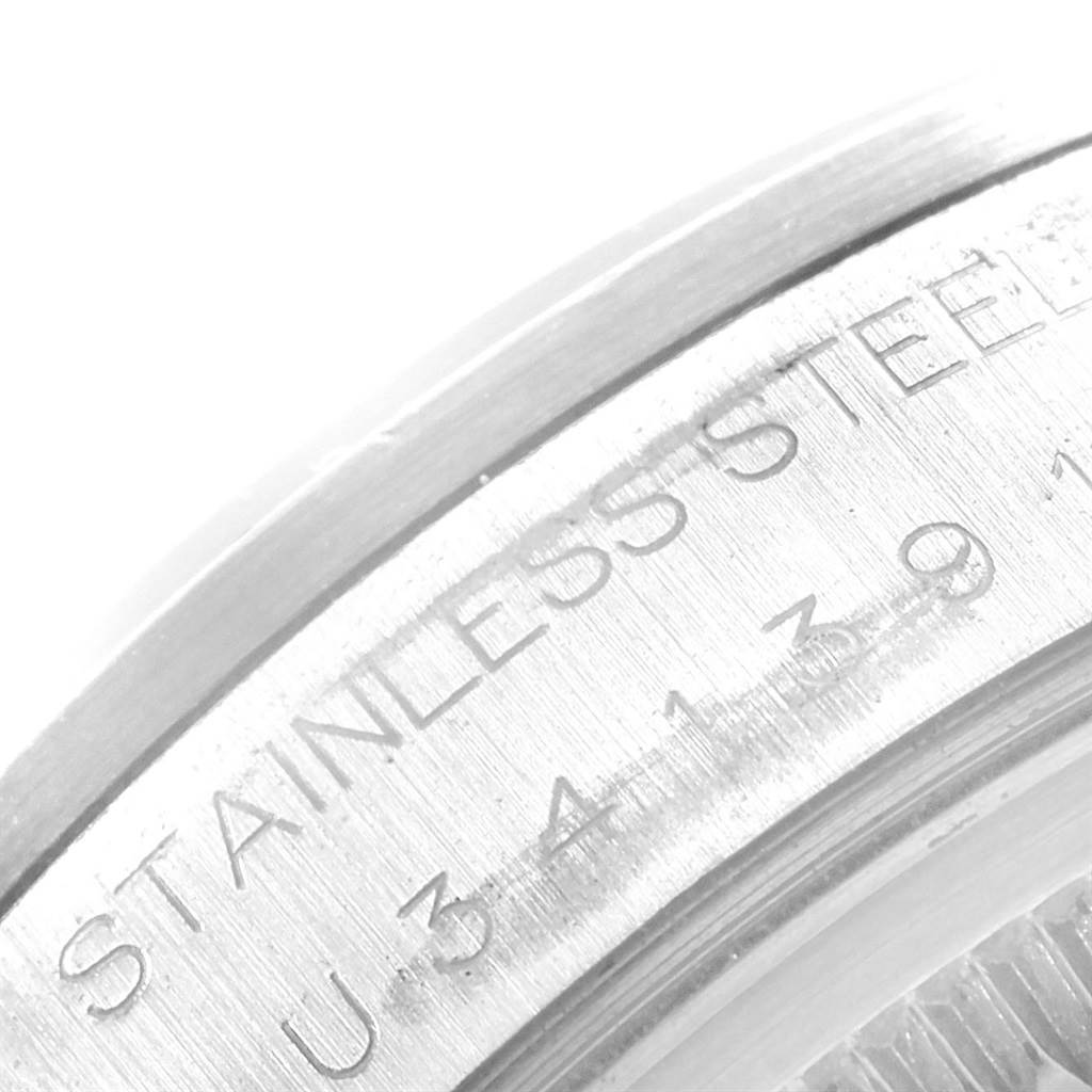 This close-up image shows part of the stainless steel case and engravings of the Rolex Air-King 14000 Men's Stainless Steel White Dial 14000 Men's Stainless Steel White Dial watch.