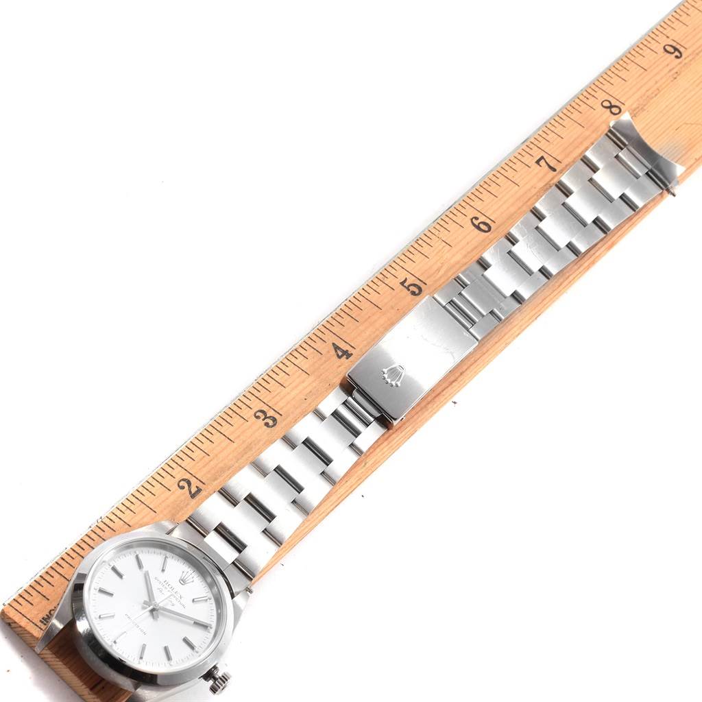 The Rolex Air-King 14000 Men's Stainless Steel Silver Dial 14000 Men's Stainless Steel Silver Dial watch is shown laid flat with its full bracelet and clasp visible, next to a ruler.