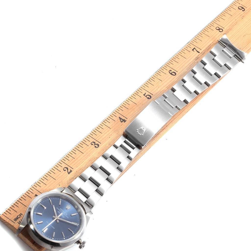 The image shows the Rolex Air-King 14000 Men's Stainless Steel Blue Dial 14000 Men's Stainless Steel Blue Dial watch laid flat on a ruler, showcasing the face, band, and clasp.