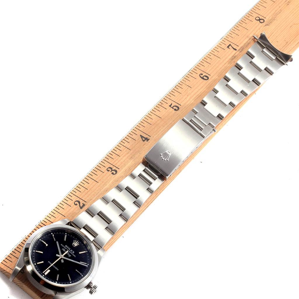 A Rolex Air-King 14000 Men's Stainless Steel Black Dial 14000 Men's Stainless Steel Black Dial watch is shown horizontally with the face and bracelet, measured against a ruler.