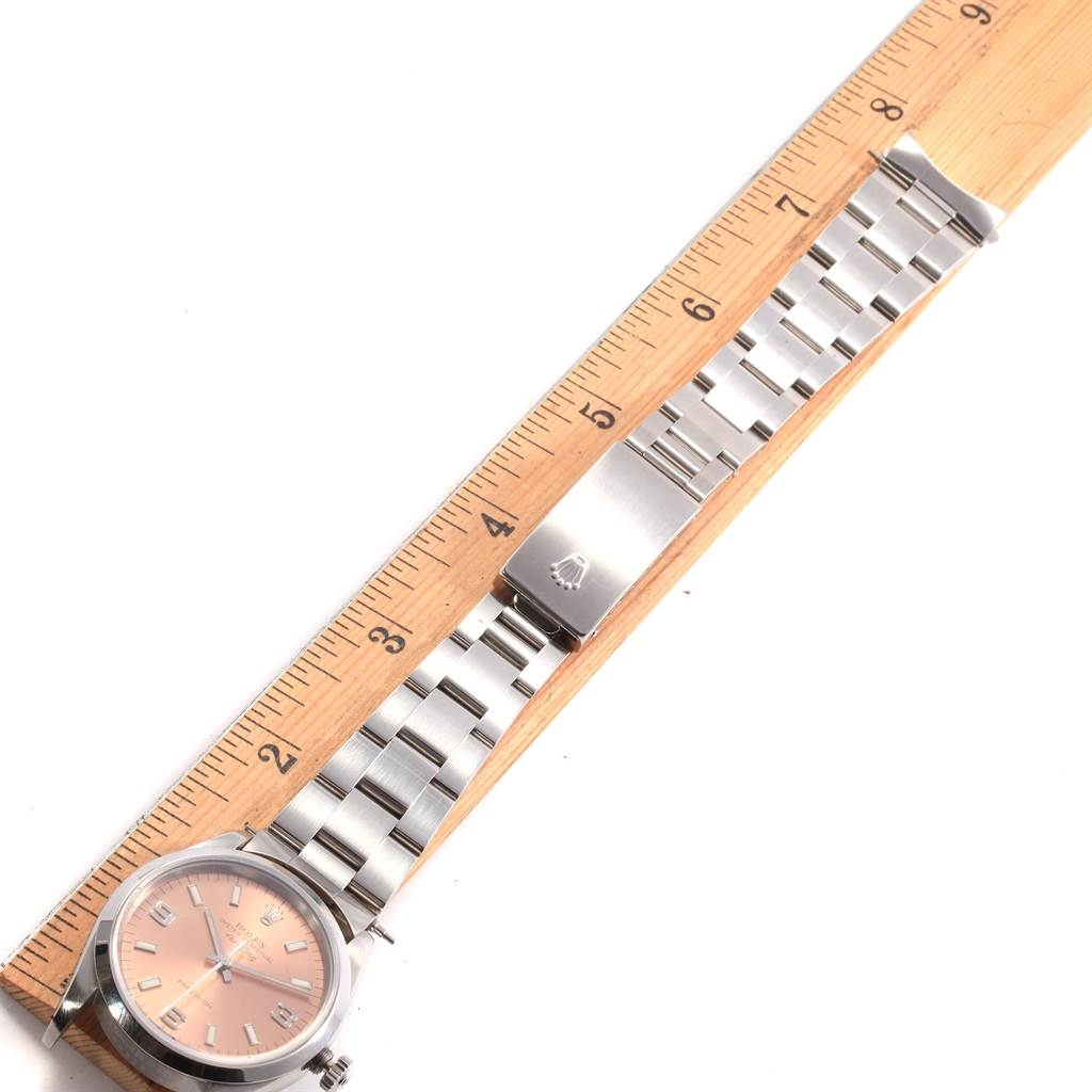 The image shows a Rolex Air-King 14000 Stainless Steel Pink Dial 14000 Stainless Steel Pink Dial watch lying flat with its bracelet fully extended and partially measured against a wooden ruler.