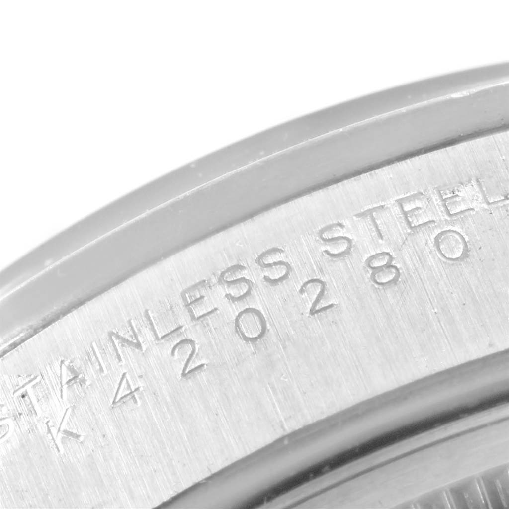 The image shows a close-up of the outer case back of a Rolex Air-King 14000 Men's Stainless Steel White Dial 14000 Men's Stainless Steel White Dial watch, highlighting engraved text on the stainless steel surface.