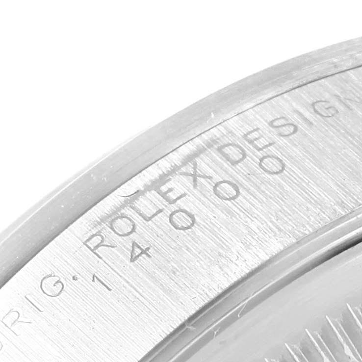 This close-up image of a Rolex Air-King 14000 Men's Stainless Steel Blue Dial 14000 Men's Stainless Steel Blue Dial watch shows the engraving on the case back, highlighting the model information.