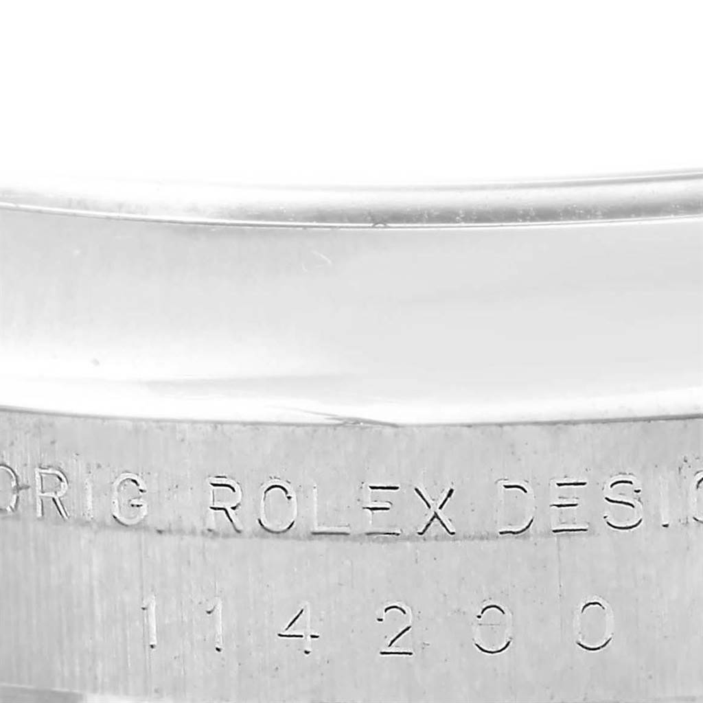 Close-up of the engraved case side of a Rolex Air-King 114200 Men's Stainless Steel Blue Dial 114200 Men's Stainless Steel Blue Dial model showing the original design text and model number.