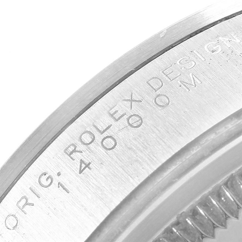 A close-up of the side of a Rolex Air-King 14000 Men's Stainless Steel Blue Dial 14000 Men's Stainless Steel Blue Dial watch case, showing engravings on the metal.