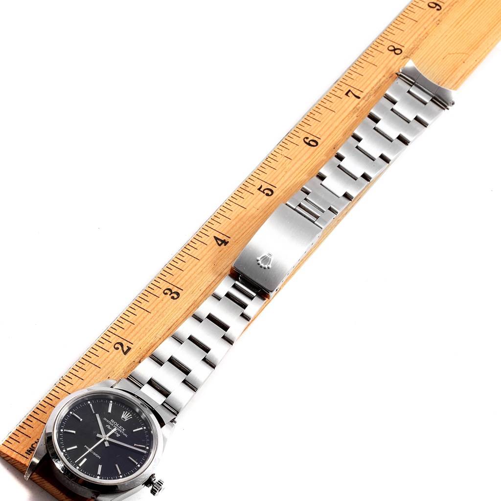The Rolex Air-King 14000 Men's Stainless Steel Black Dial 14000 Men's Stainless Steel Black Dial watch is displayed from a top-down angle, showing the face, bracelet, and clasp, measured against a ruler.