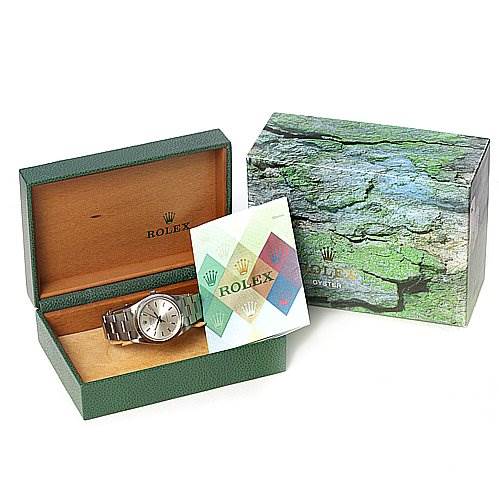 The Rolex Air-King 1400 Men's Stainless Steel Silver Dial 1400 Men's Stainless Steel Silver Dial watch is shown in an open green box with a manual and an outer decorative box.