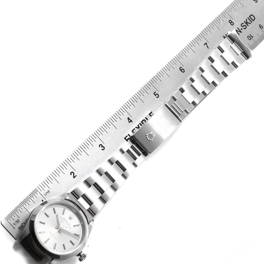 The image shows the Rolex Air-King Men's Stainless Steel Silver Dial Men's Stainless Steel Silver Dial watch laid flat, with a flexible ruler measuring the bracelet's length.