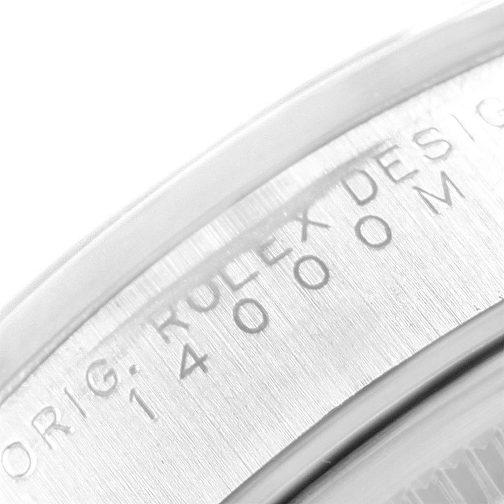 The image shows a close-up of the case detailing of a Rolex Air-King 14000 Men's Stainless Steel White Dial 14000 Men's Stainless Steel White Dial watch, highlighting the engraved "ROLEX DESIGN" and model number.