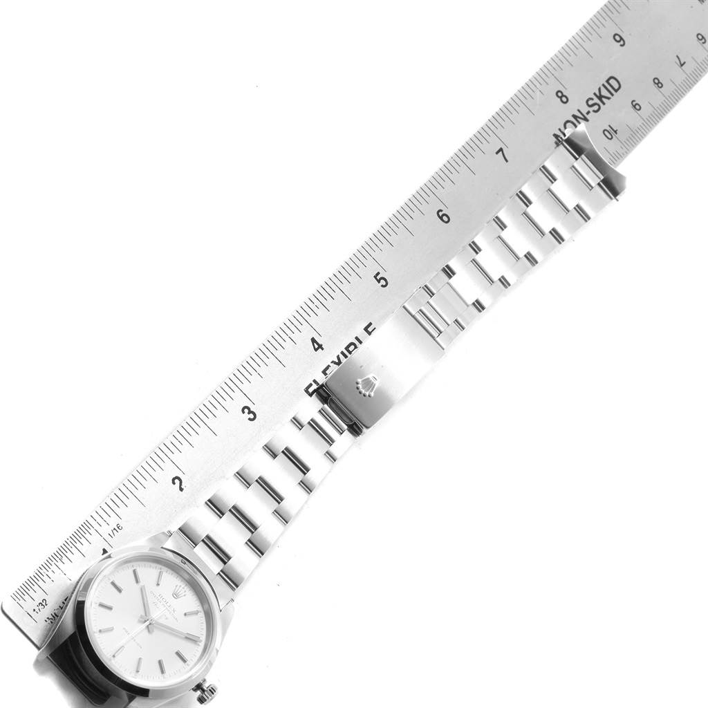 The Rolex Air-King 14000 Men's Stainless Steel Silver Dial 14000 Men's Stainless Steel Silver Dial watch is shown from an aerial view, featuring the face, bracelet, and clasp with a ruler for scale.