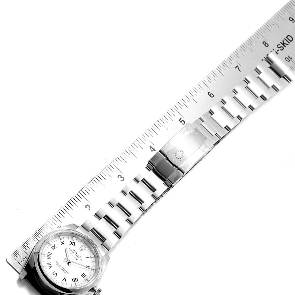 The image shows a top-down view of a Rolex Air-King 114200 Men's Stainless Steel White Dial 114200 Men's Stainless Steel White Dial watch, with a focus on the bracelet and clasp, alongside a ruler for size reference.