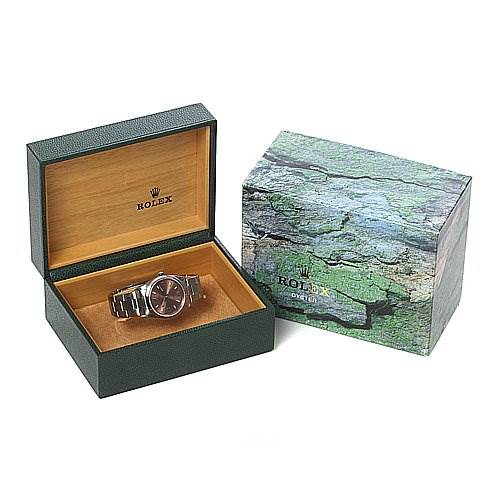The image shows a Rolex Air-King 14000M Men's Stainless Steel Brown Dial 14000M Men's Stainless Steel Brown Dial watch placed inside an open green and brown box, next to a closed outer box.