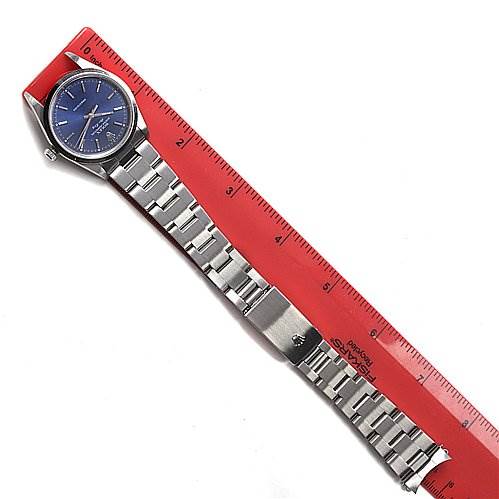 The image displays a Rolex Air-King 14000M Men's Stainless Steel Blue Dial 14000M Men's Stainless Steel Blue Dial watch lying flat beside a red ruler, showing both the face and the full length of the strap.