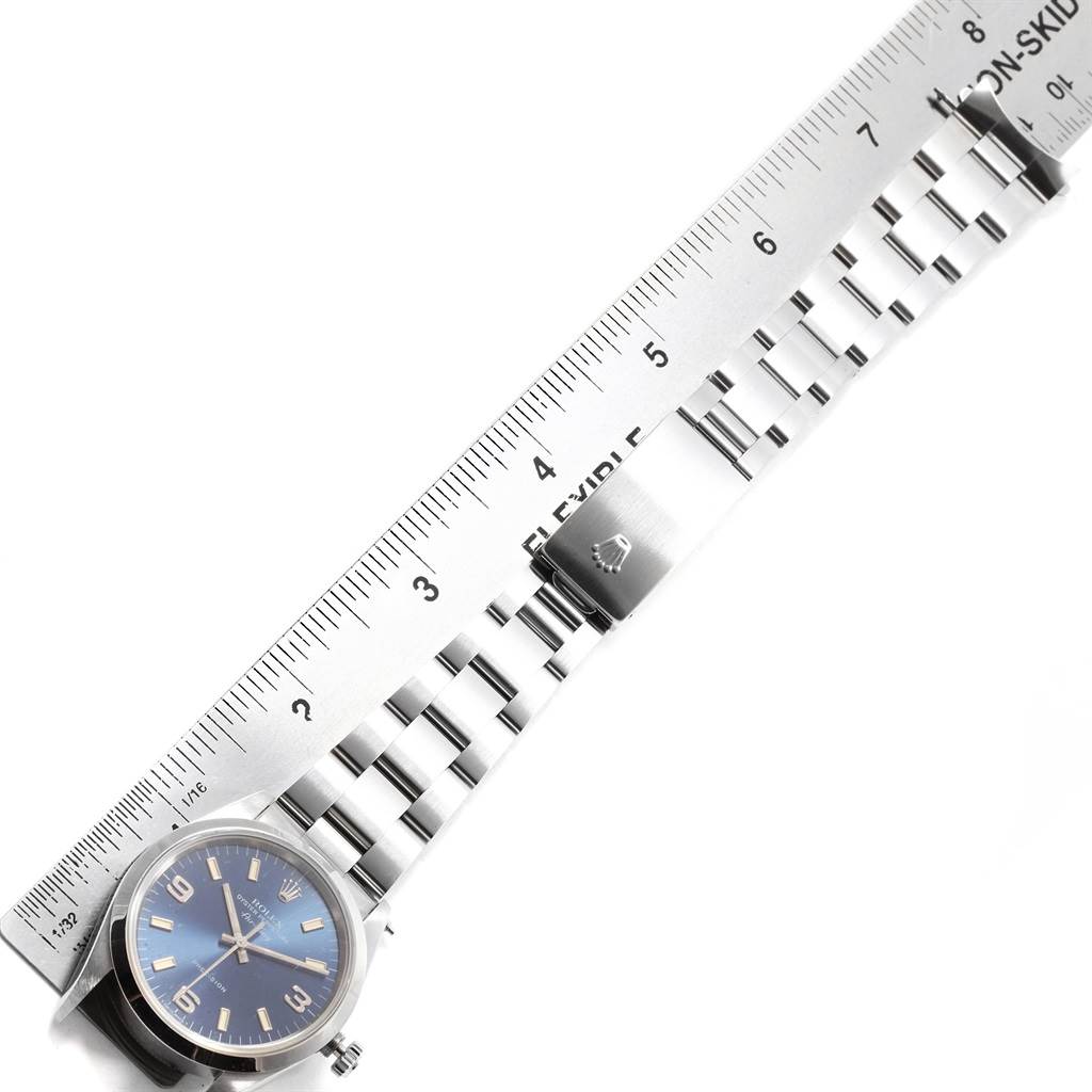 The image displays the full length of a Rolex Air-King 14000 Men's Stainless Steel Blue Dial 14000 Men's Stainless Steel Blue Dial watch, including its dial, bracelet, and clasp, alongside a ruler for scale.