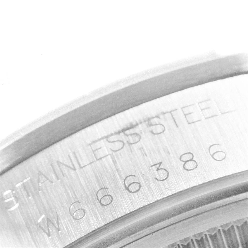 This is a close-up shot of the serial number and "STAINLESS STEEL" engraving on the case of a Rolex Air-King 14000 Men's Stainless Steel Blue Dial 14000 Men's Stainless Steel Blue Dial watch.