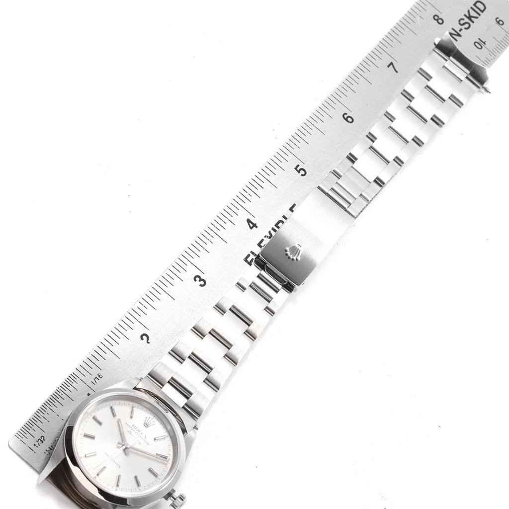 The image shows a Rolex Air-King 14000 Men's Stainless Steel Silver Dial 14000 Men's Stainless Steel Silver Dial watch laid flat, alongside a ruler, displaying the face, bracelet, and clasp.