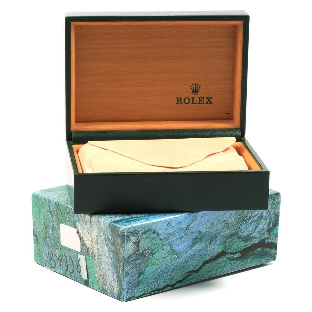 This image shows an open Rolex box for the Air-King model, with a green and brown interior and an outer box with a green marbled pattern.