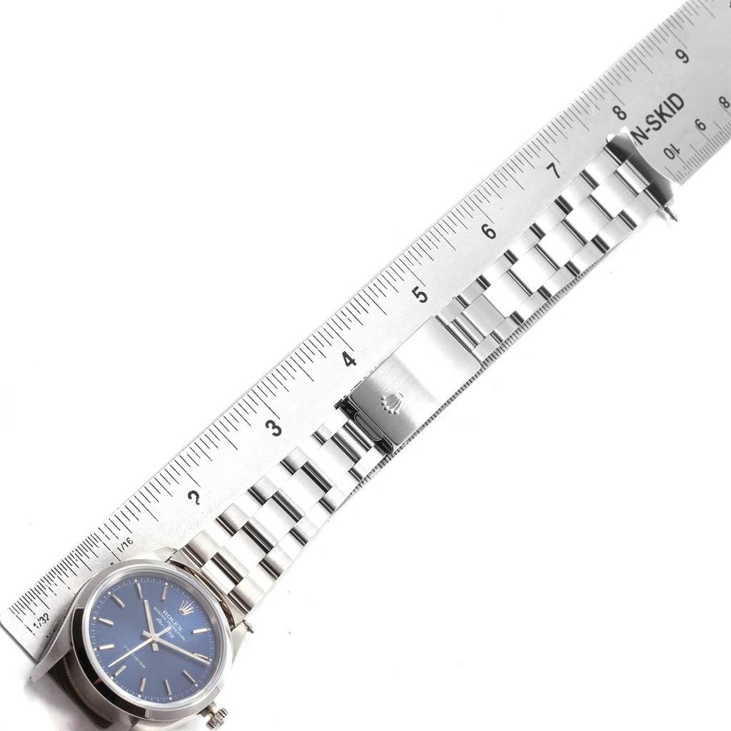 The image shows a Rolex Air-King 19794 Men's Stainless Steel Blue Dial 19794 Men's Stainless Steel Blue Dial model watch laid flat with a ruler measuring its metal bracelet clasp.
