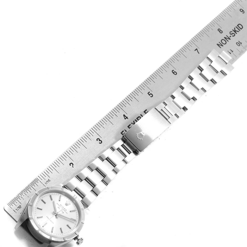 The image shows a Rolex Air-King 14010 Men's Stainless Steel Silver Dial 14010 Men's Stainless Steel Silver Dial watch with its dial and metal bracelet partially measured by a ruler.