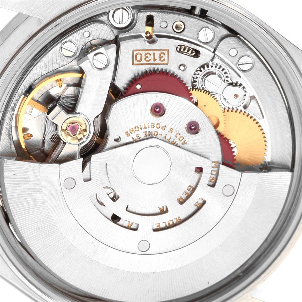 This image shows a close-up view of the movement mechanism of a Rolex Air-King 14010 Men's Stainless Steel Silver Dial 14010 Men's Stainless Steel Silver Dial watch with visible gears and components.