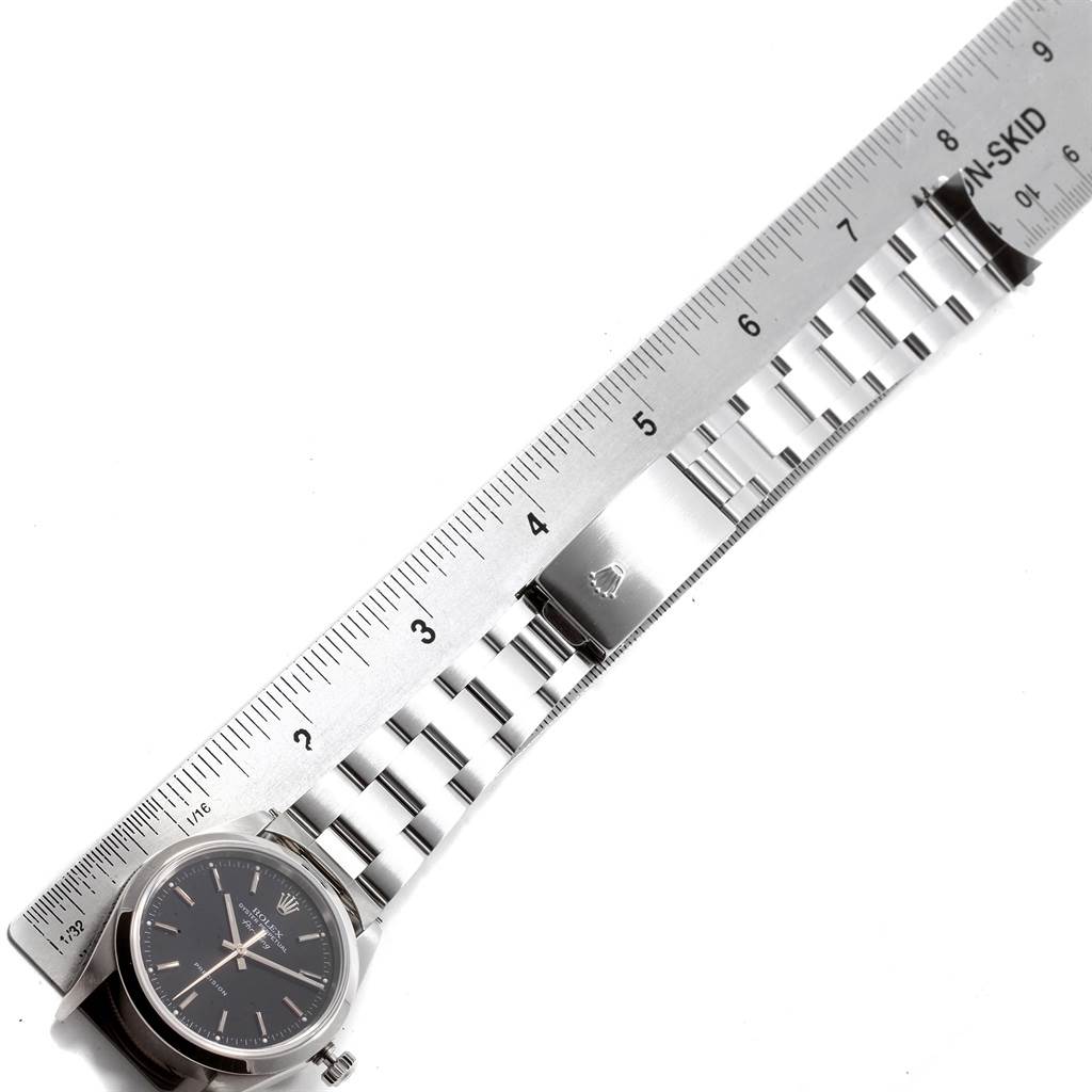 The image shows a Rolex Air-King 14000 Men's Stainless Steel Black Dial 14000 Men's Stainless Steel Black Dial watch and stainless steel bracelet, photographed from above alongside a ruler for scale.