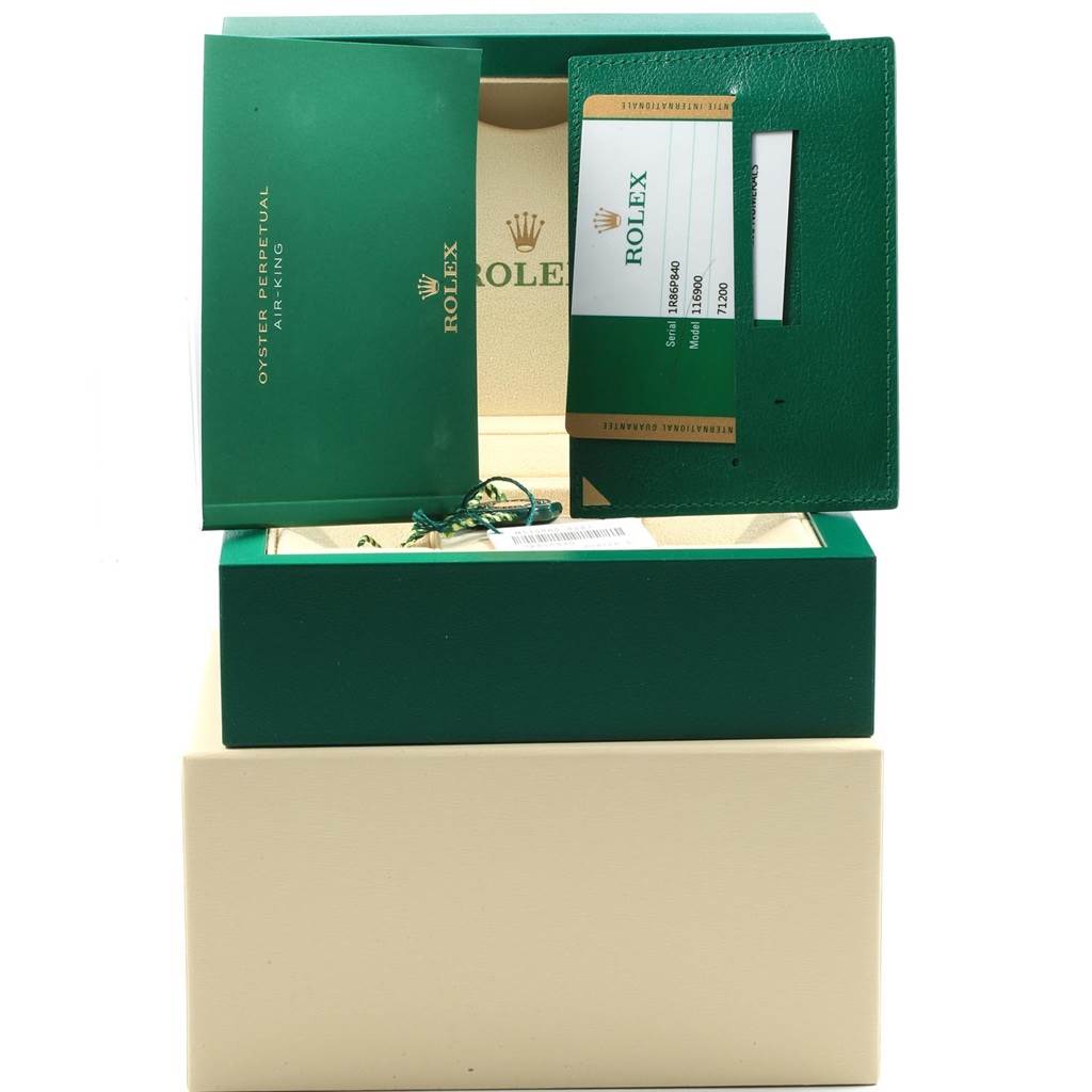 The image shows the packaging and documentation for a Rolex Air-King 116900 Men's Stainless Steel Black Dial 116900 Men's Stainless Steel Black Dial watch, including the green box and warranty card.