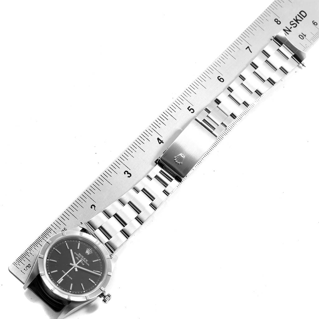 The image shows a Rolex Air-King 14010 Men's Stainless Steel Black Dial 14010 Men's Stainless Steel Black Dial watch laid flat, displaying the watch face, bracelet, and clasp next to a measuring ruler.