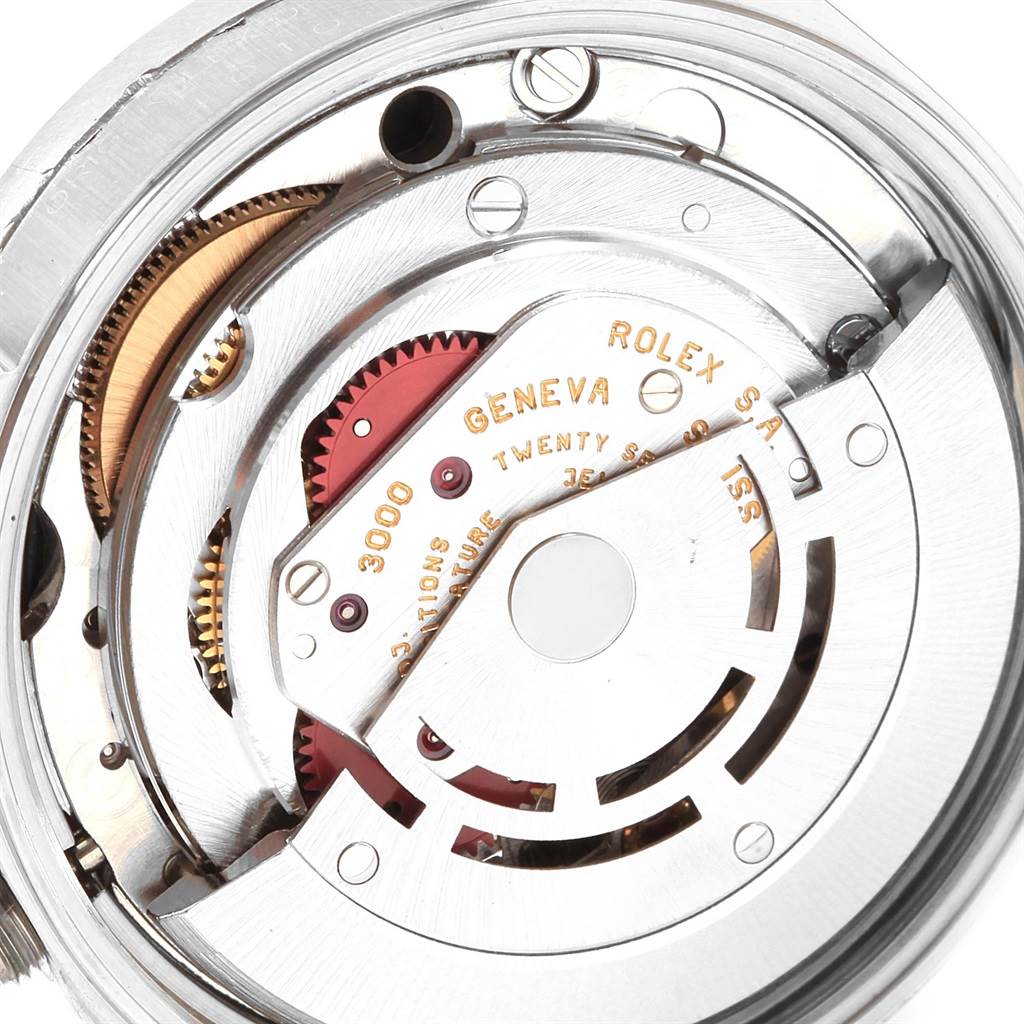This image shows the internal mechanism of a Rolex Air-King 14010 Men's Stainless Steel Black Dial 14010 Men's Stainless Steel Black Dial watch, focusing on the movement with visible gears and engravings.