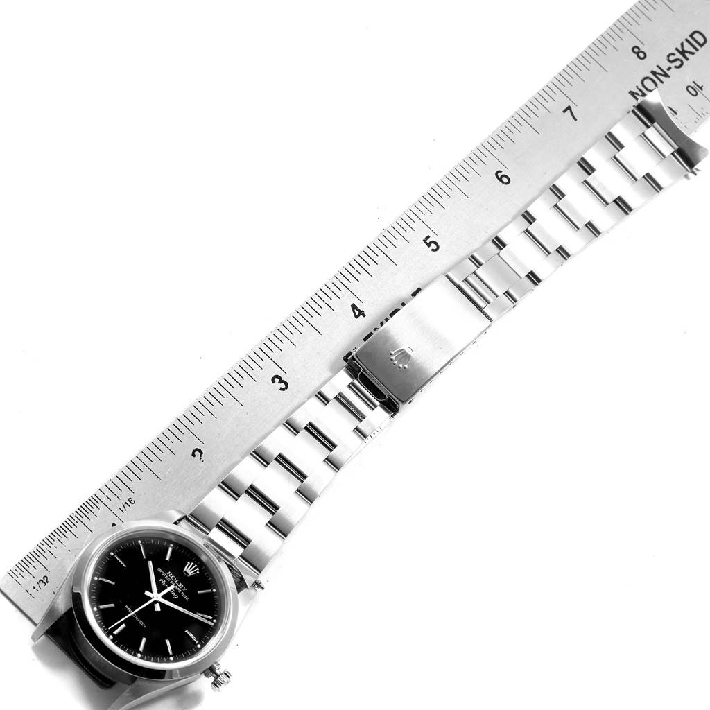 The image shows a side angle of a Rolex Air-King 19798 Men's Stainless Steel Black Dial 19798 Men's Stainless Steel Black Dial watch, highlighting its stainless steel bracelet and clasp, measured against a ruler.