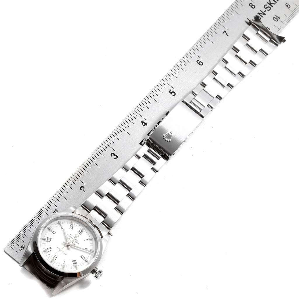 The image shows a top-down view of a Rolex Air-King 14000 Men's Stainless Steel White Dial 14000 Men's Stainless Steel White Dial watch, including the face, bracelet, and clasp, alongside a ruler for scale.