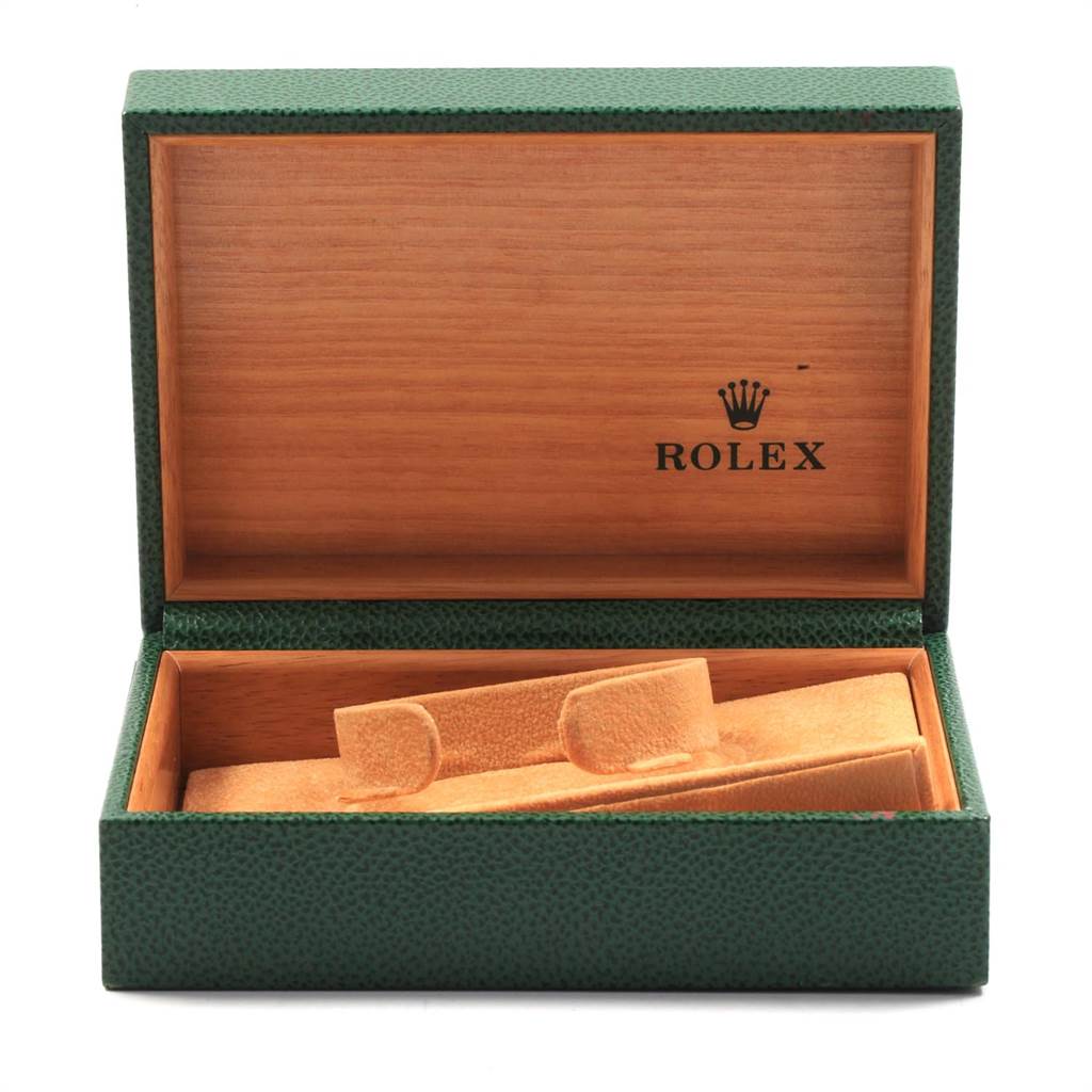 A green and wooden open box for a Rolex Air-King 14000 Men's Stainless Steel White Dial 14000 Men's Stainless Steel White Dial watch, with an empty watch cushion inside.