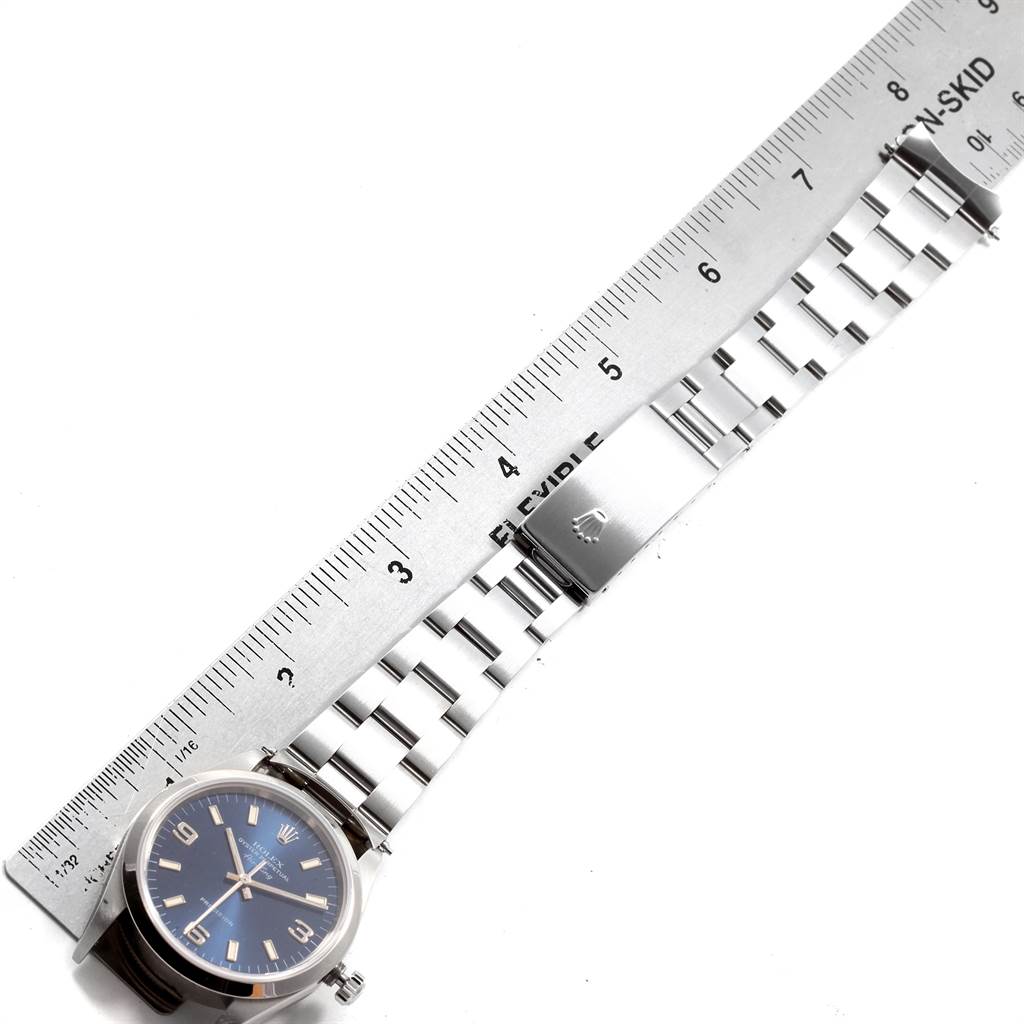 The image shows a Rolex Air-King 14000 Men's Stainless Steel Blue Dial 14000 Men's Stainless Steel Blue Dial watch from an overhead angle, highlighting its face, bezel, and metal bracelet next to a flexible ruler.
