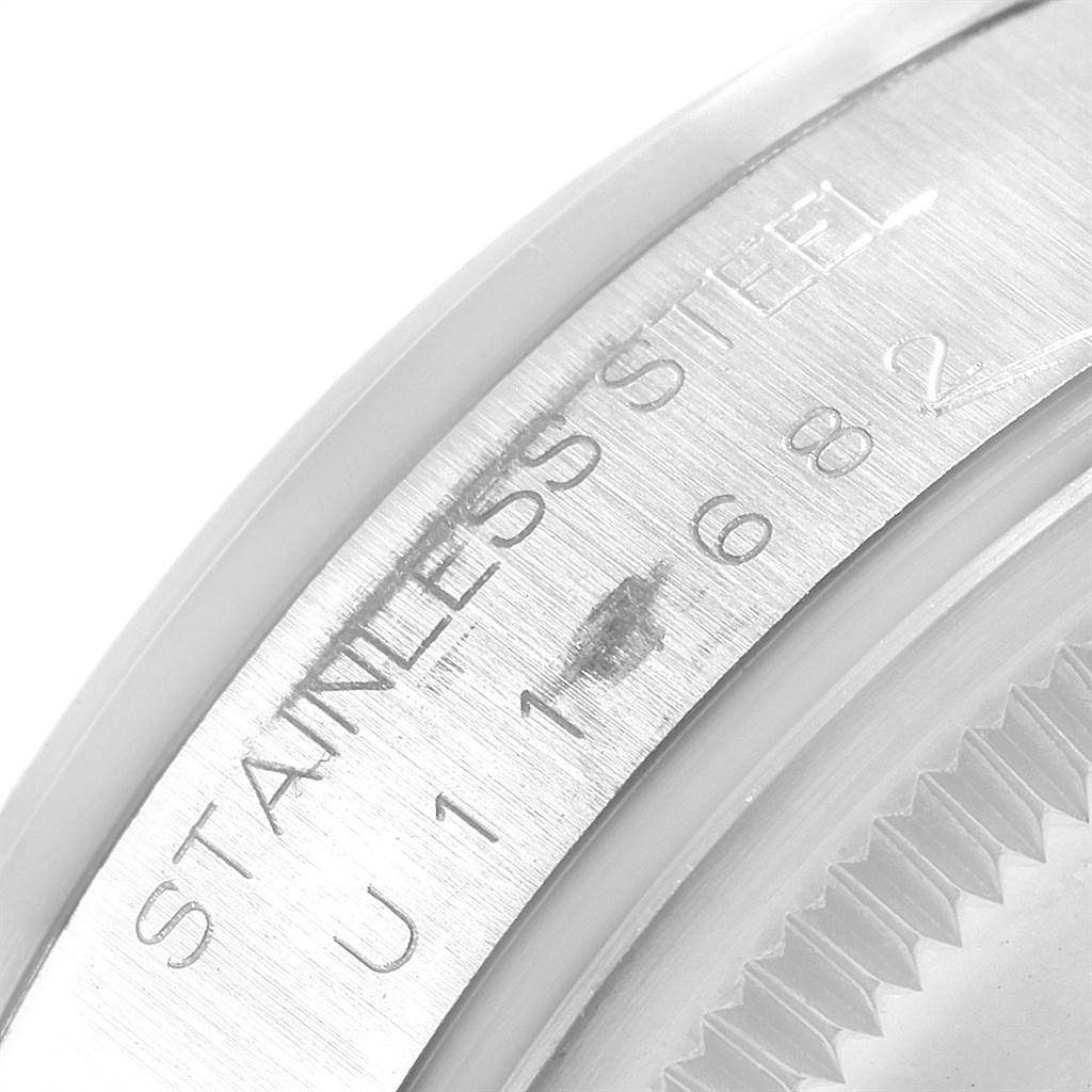 This image shows a close-up of the serial number and "STAINLESS STEEL" engraving on the side of a Rolex Air-King 14000 Men's Stainless Steel Blue Dial 14000 Men's Stainless Steel Blue Dial watch case.