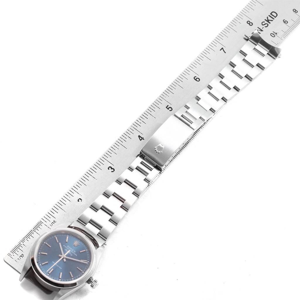 The image shows a top-down view of a Rolex Air-King 14000 Men's Stainless Steel Blue Dial 14000 Men's Stainless Steel Blue Dial watch, highlighting the dial, bracelet, and clasp alongside a ruler for scale.