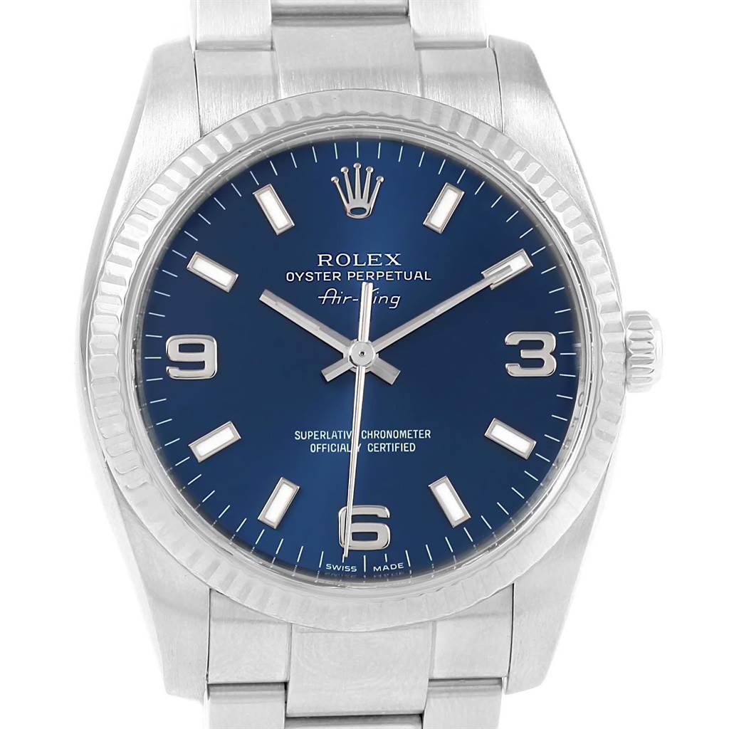 The Rolex Air-King 114234 Men's Stainless Steel Blue Dial 114234 Men's Stainless Steel Blue Dial watch is shown from a front angle, displaying its blue dial, hands, crown, and part of the bracelet.