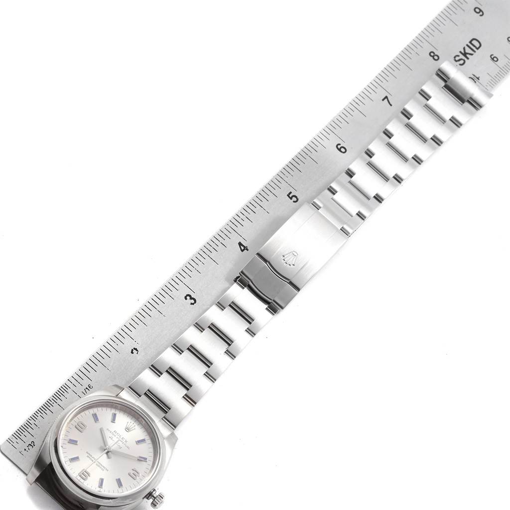 This image shows the Rolex Air-King 114200 Men's Stainless Steel Silver Dial 114200 Men's Stainless Steel Silver Dial watch laid flat, displaying the face, bracelet, and clasp with a ruler for scale.
