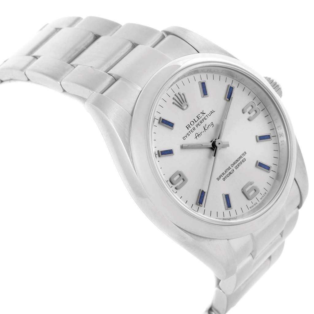 The Rolex Air-King 114200 Men's Stainless Steel Silver Dial 114200 Men's Stainless Steel Silver Dial watch is shown at an angle showcasing its face, bracelet, and part of the crown.