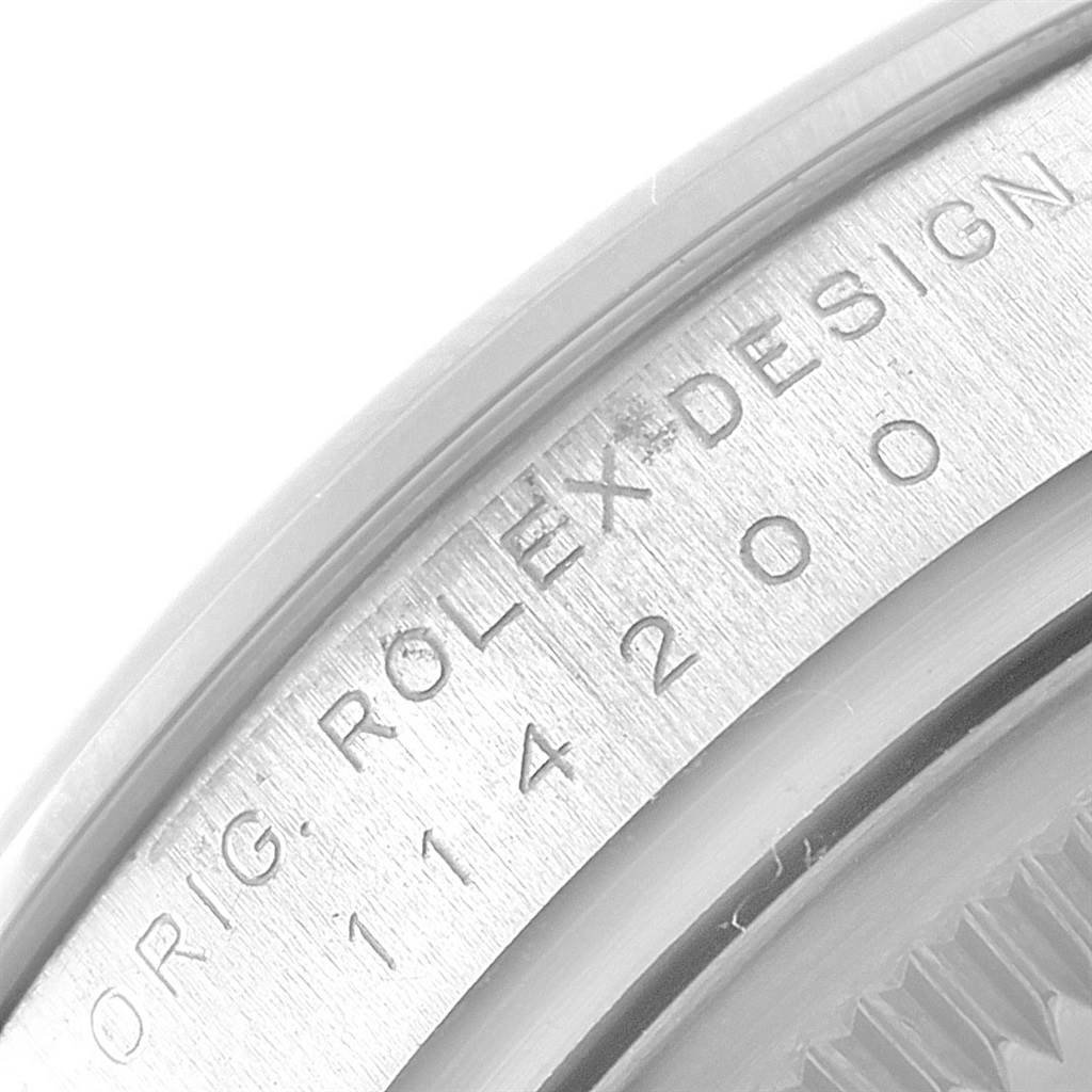 This close-up angle shows the engraved case back edge of the Rolex Air-King 114200 Men's Stainless Steel Silver Dial 114200 Men's Stainless Steel Silver Dial watch, detailing the model and design information.