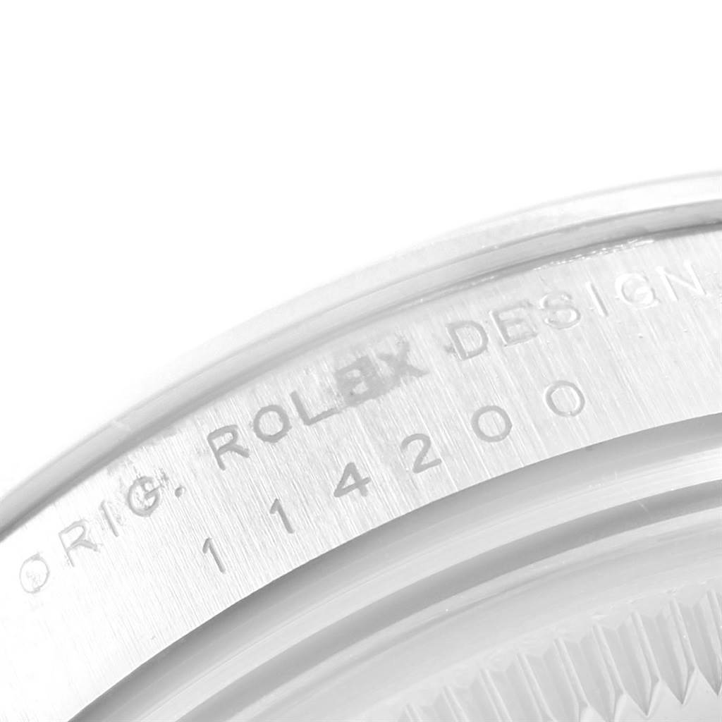 The image shows a close-up of the case side where "Rolex Design" and the model number of the Rolex Air-King 20465 Men's Stainless Steel Silver Dial 20465 Men's Stainless Steel Silver Dial watch are engraved.