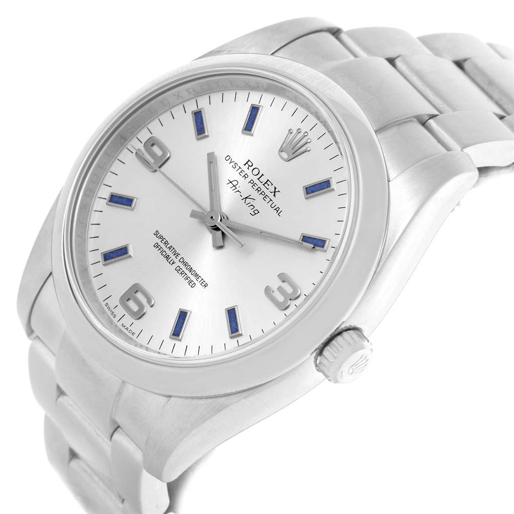 A Rolex Air-King 114200 Men's Stainless Steel Silver Dial 114200 Men's Stainless Steel Silver Dial watch is shown from an angled close-up view, highlighting the dial, hands, crown, and metal bracelet.