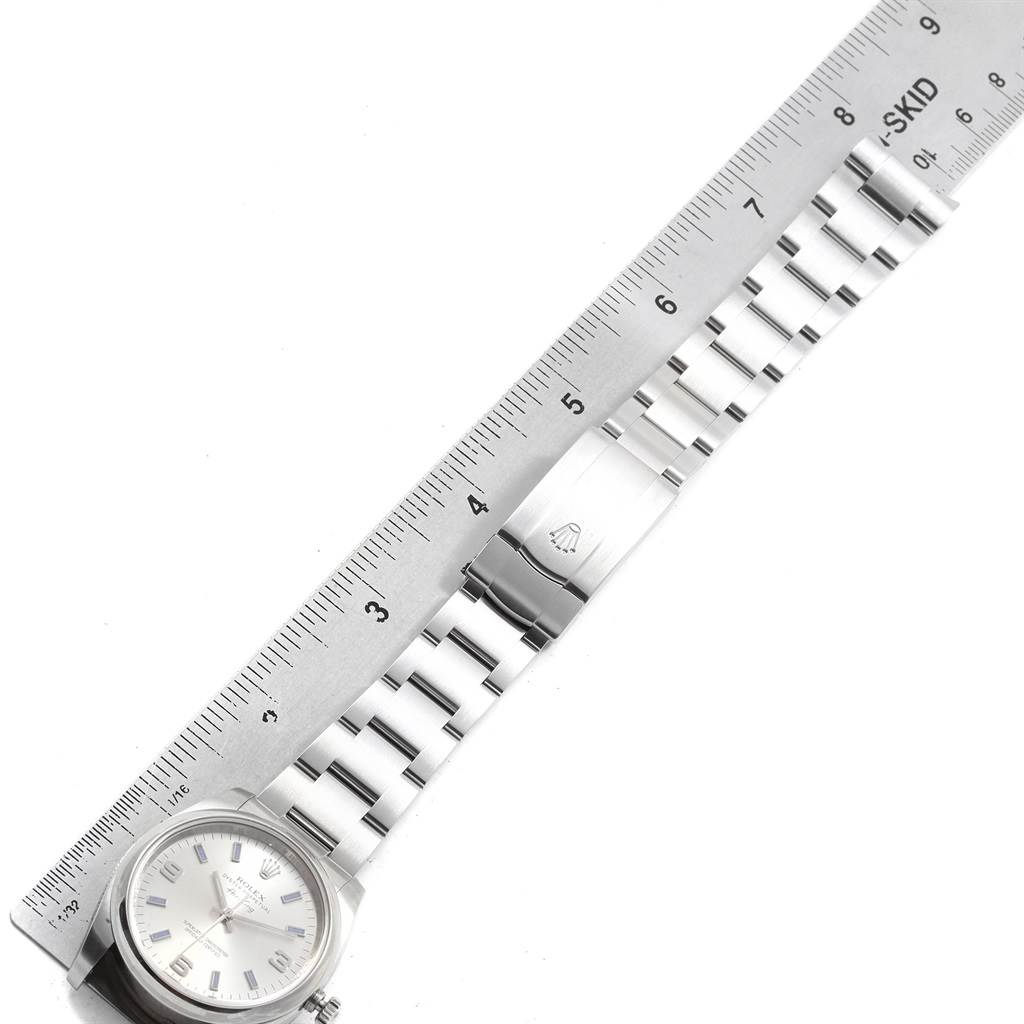 The image shows a Rolex Air-King 114200 Men's Stainless Steel Silver Dial 114200 Men's Stainless Steel Silver Dial watch from a top-down angle along with a ruler for size reference.