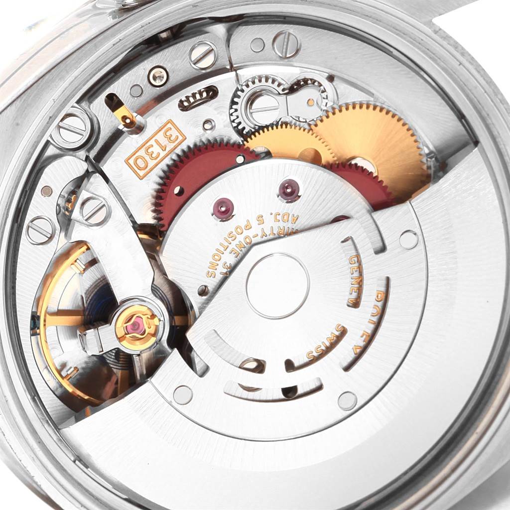 This image shows a close-up of the internal mechanism of a Rolex Air-King 114200 Men's Stainless Steel Silver Dial 114200 Men's Stainless Steel Silver Dial watch, revealing its intricate gears and movement components.