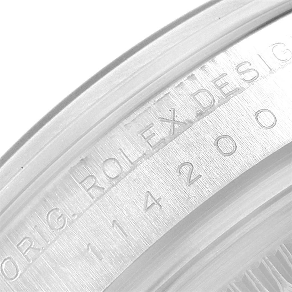 This close-up image shows the engraved watch model number and "Rolex Design" text on the case side of the Rolex Air-King 114200 Stainless Steel White Dial 114200 Stainless Steel White Dial.