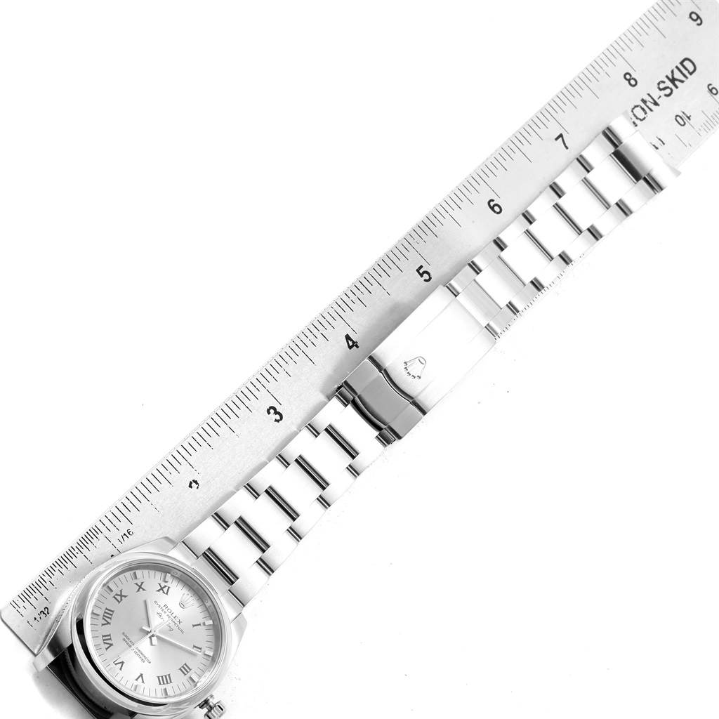 The image shows a Rolex Air-King 114200 Stainless Steel White Dial 114200 Stainless Steel White Dial watch laid flat with a ruler measuring the stainless steel bracelet and clasp.